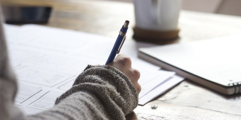 Person studying documents at a desk
